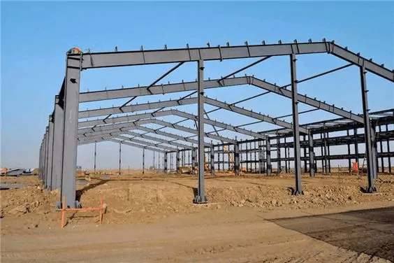 Side view of a pre-engineered steel building frame during site erection
